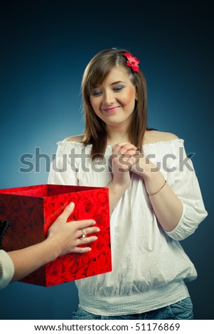 beautiful girl receives opened gift box
