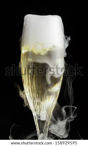 champagne flute with ice vapor, black background