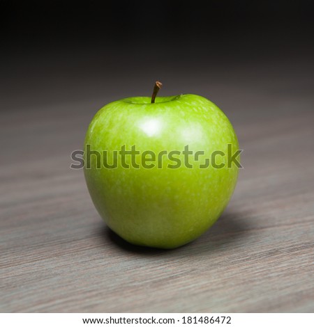 granny smith green apple against wooden background