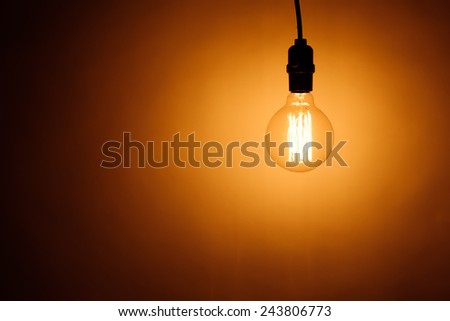 bulb lamp with warm light, copy-space background