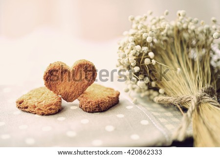 Bread cut in the shape of hearts on colorful polka dot tablecloth, with dried flowers. Concept about bad relationship and broken heart (Vintage Style) Foto stock © 