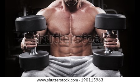 Bodybuilder men training at the gym with dumbbell