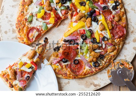 pizza pie on a stone sliced up