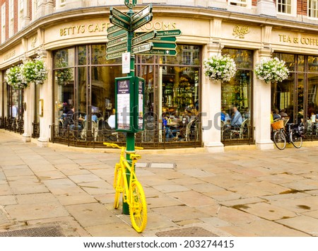 YORK, NORTH YORKSHIRE, UNITED KINGDOM: JULY 5TH. Betty\'s Tea Rooms, York, England. Yellow bike relates to Tour De France taking place in Yorkshire. 6-8 St Helena?s Square, York, UK. July 5th 2014.