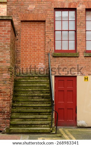 NOTTINGHAM, ENGLAND - APRIL 12: Steps lead nowhere to a bricked up doorway, with graffiti tags. On 12th April, 2015, in Nottingham, England.