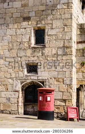 YORK, ENGLAND - MAY 20: The ancient gate house at Gillygate, York. A red Royal Mail post box in front. In York, England, on 20th May 2015.
