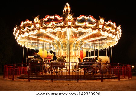 Merry-Go-Round (carousel) illuminated at night. The picture was taken near Paris, France