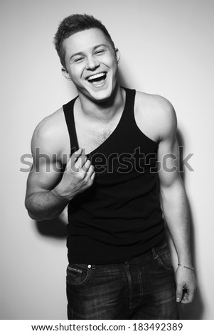 Handsome gorgeous young man in shirt indoor smiling. Black and White