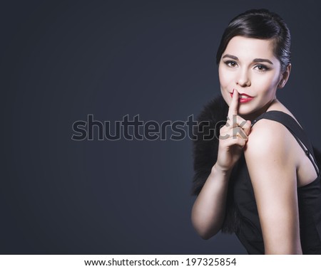 Beautiful Brunette Retro Woman with red lips make up and wave bang hairstyle make shh! Copy Space