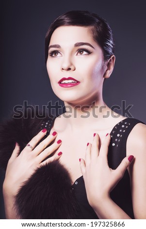 Beautiful Brunette Retro Woman with red lips make up and wave bang hairstyle looking up