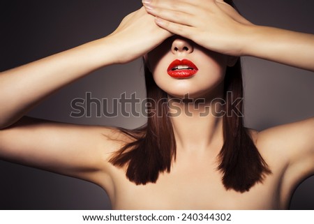 Beauty close up portrait of a brunette woman with red lipstick. Pure skin. Toned image