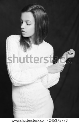 Beautiful woman in white sweater on black background. Black and White. Monochrome portrait. Dramatic. Sensual