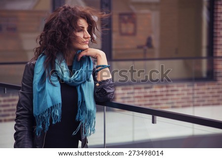 Brunette beautiful stylish caucasian woman in casual outfit on a walk on european city street. copy space
