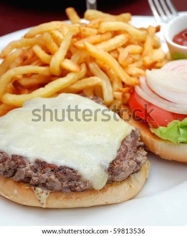 delicious isolated american cheese burger with fries on background