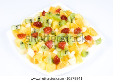 Salad from fresh appetizing fruit on a white background.