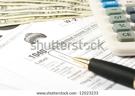 United States Tax Form, calculator, dollars and pen