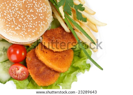 Hamburger, french fries, chicken nuggets, and vegetables on a white background