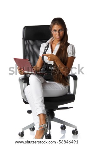 The attractive young woman with the laptop sits in an armchair on a white background.