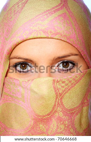 A portrait of an arabic woman face hidden behind a beautiful scarf