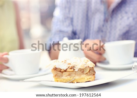 A picture of a piece of apple pie served on a white plate in a cafe