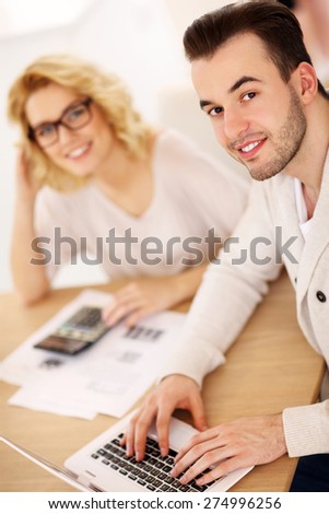 A picture of a young couple working on documents at home