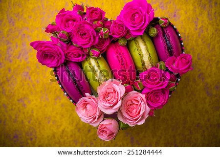 present box with flowers and macaroons yellow  background