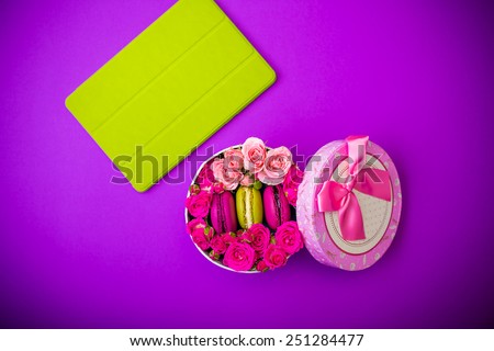 present box with flowers macaroons and tablet violet background for valentines mother day easter with love