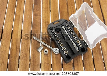 Background image of socket wrench set on the wood slat