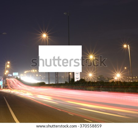 Speeding cars on modern Road infrastructure with blank hoarding for text messages, artistic long exposure shot Stock foto © 