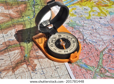 Compass and  maps. Compass on the map - this is the open door to the country adventure.