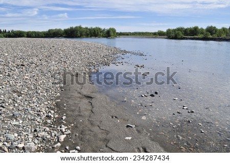 Summer river landscape of the Polar Urals. Valley North of the river are lined with pebbles.