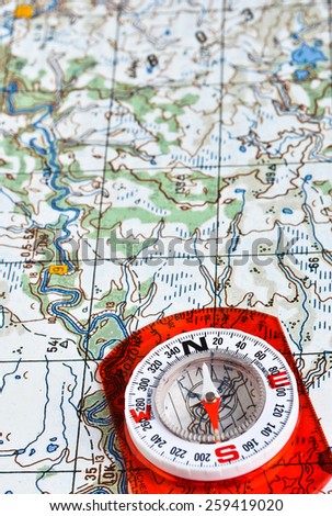 The magnetic compass and topographic map. Travel compass and map symbols adventures.