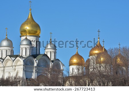Golden domes of Orthodox churches of the Moscow Kremlin. Gilded dome on the background of blue sky.