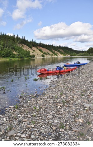 Inflatable kayaks on the shore taiga rivers. The river of the polar Urals in the Republic of Komi, Russia.