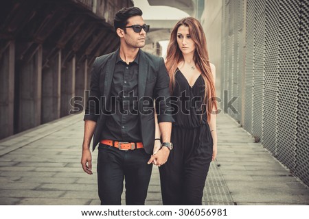 Young and trendy man and woman models walks of the modern street. Fashion Style