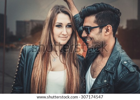 Young and trendy man and woman models smiling and feeling happyt. Fashion Style
