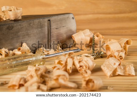 Carpenters table with wood plane, shavings and screw driver