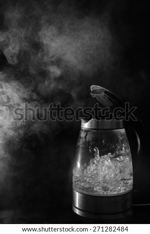 Kettle boiling with steam, black and white.