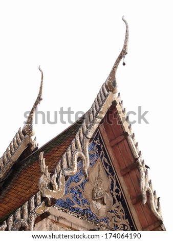 Part of top front side of a Thai buddhism temple architecture middle Thailand style in Chachongsao province with stepping roofs with hanging bells, decorative Thai ornaments and bas-relief sculpture.