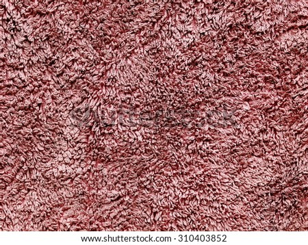 closeup surface texture of a red brown microfibre, micro fiber kitchen cloth used, dirty and dry with uneven fiber pattern