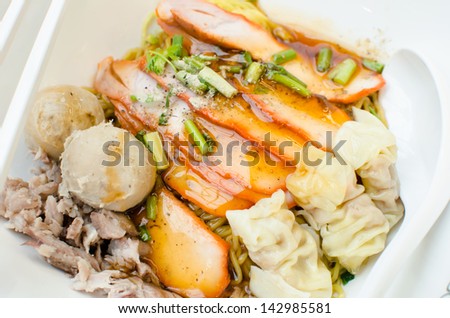 Egg chinese dry noodles with roast red pork, dumpling and vegetables