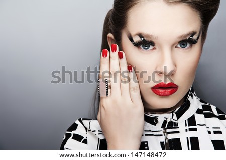 young attractive sensual  woman with beautiful art  abstract make-up and ring. Glamour red lips and red nails