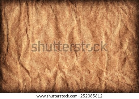 Photograph of old Recycle Kraft Brown Paper, coarse grain, crushed crumpled, vignette grunge texture sample.
