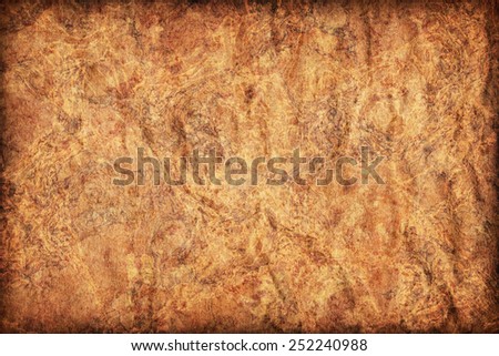 Photograph of old Recycle Kraft Brown Paper, coarse grain, crushed crumpled, mottled, vignette grunge texture sample.