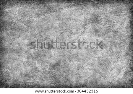 Photograph of old Gray animal skin parchment, creased, coarse, vignette grunge texture sample.