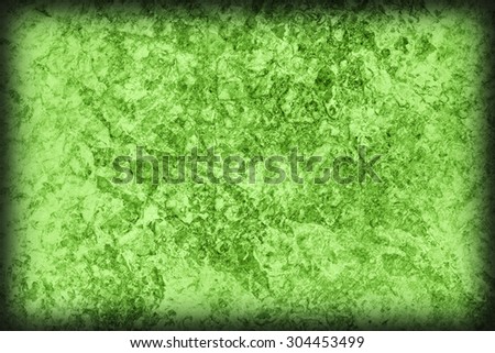 Photograph of old Green Animal Skin Parchment, creased, coarse, vignette grunge texture sample.