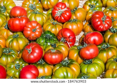 Selection of red, green and yellow tomatoes taken at a organic French farmer\'s market