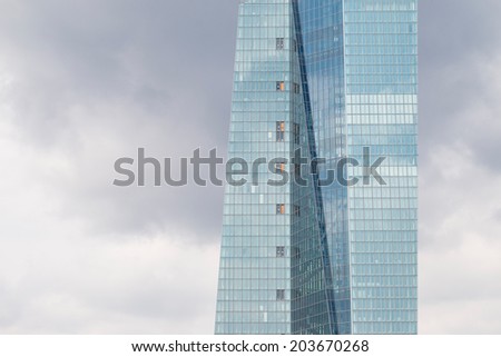 FRANKFURT JULY 06, 2014: Close up of the new European Central Bank headquarter building in front of a cloudy sky taken on July 06, 2014 in Frankfurt, Germany