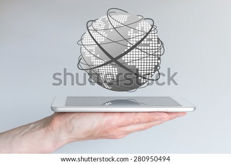Male hands holding tablet or large smart phone in order to connect to the world wide web. Concept of mobile computing and the internet. Visualization with world and connecting lines.