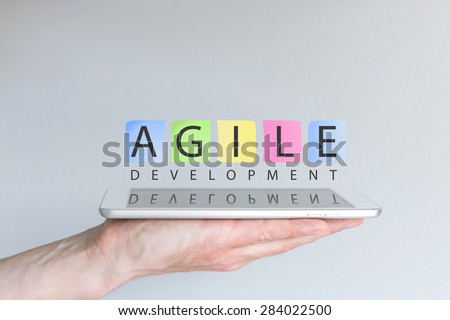Agile development concept for mobile devices. Hand holding tablet.